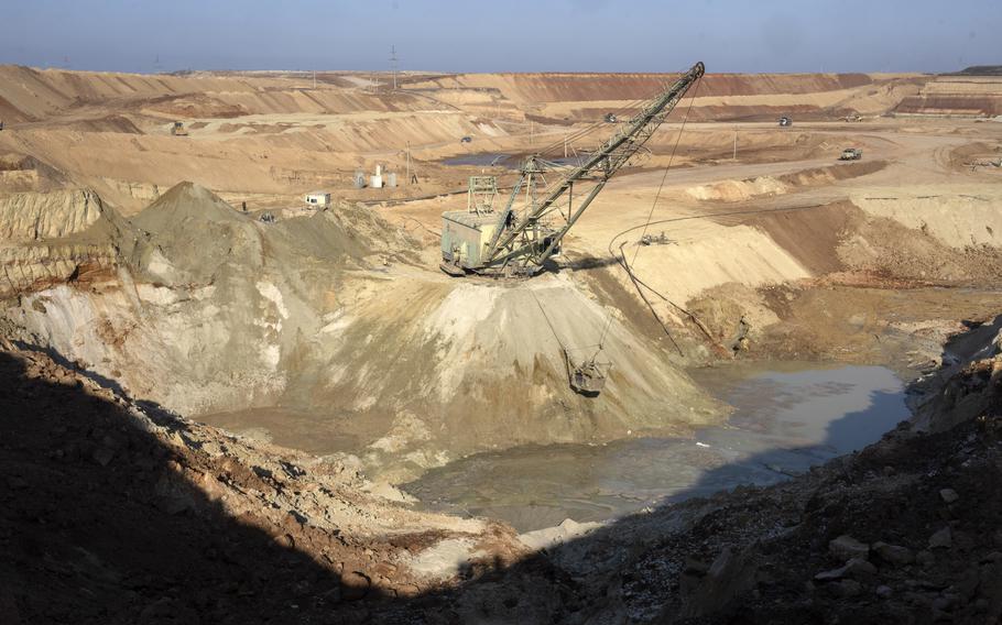 A crane operates in a mine pit.