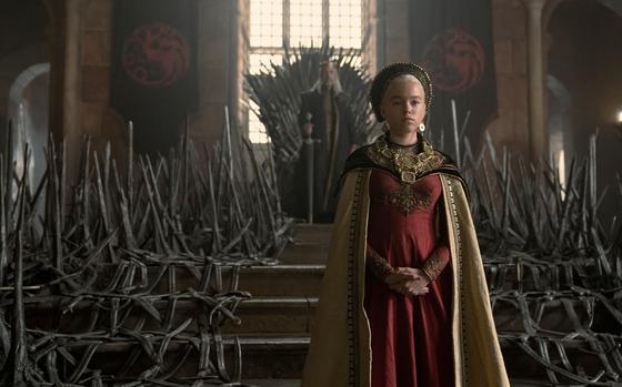 Paddy Considine, background, as King Viserys Targaryen, and Milly Alcock as young Rhaenyra in "House of the Dragon."