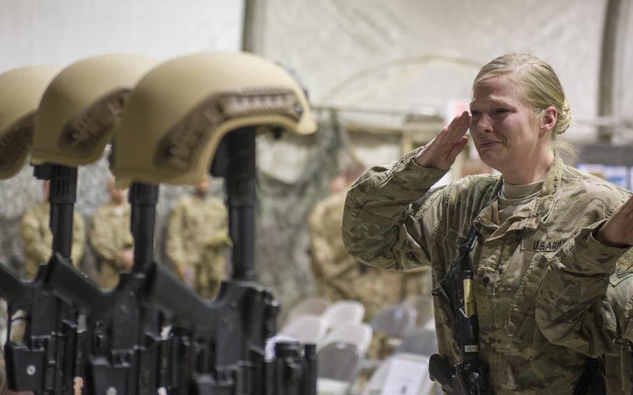 Service members from several units at Bagram Airfield, Afghanistan, pay their respects during a fallen comrade ceremony, Dec. 23, 2015, held in honor of six airmen killed by a roadside bomb near Bagram, Dec. 21, 2015.