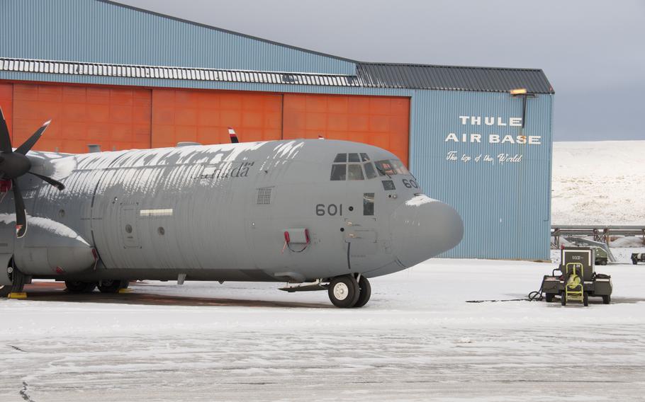 A Canadian transport plane sits on the runway in front of a hangar at Thule Air Base, Greenland, in 2014. A $3.95 billion contract has been awarded to ensure the ongoing operation of Thule, the U.S. military’s northernmost base that bills itself at the “Top of the World.”