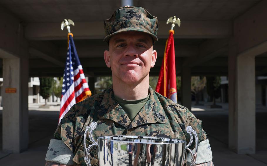 Marine Sgt. Maj. Steven Burkett, the command sergeant major of School of Infantry-West, poses with his trophy on April 10, 2023, after being recognized as Male Marine Athlete of the Year at Camp Pendleton, Calif. Burkett holds the kettlebell world record for heaviest weight lifted by kettlebell swing in one hour. 