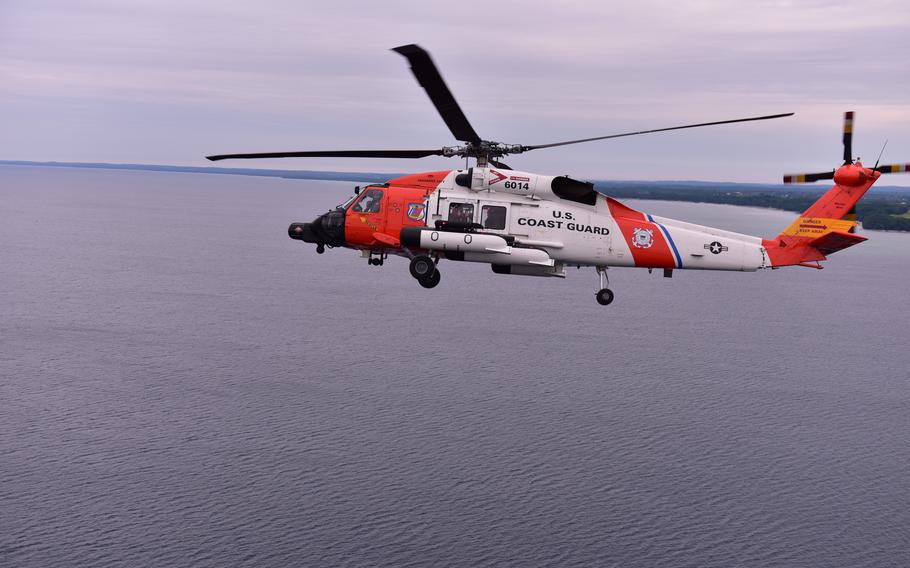 A MH-60 helicopter practices formation flying 