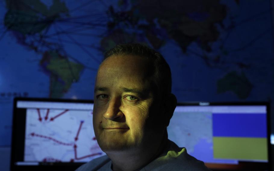 Lars Whelan, a semi-retired ship captain, sits in front of a map of all the places he has traveled, March 8, 2022. Whelan is helping manage Ukraine-related logistics from his apartment in Los Angeles. He has years of experience in international logistics and humanitarian work, which he’s been involved in in places including Nigeria and Gabon. He is now helping to manage Ukraine-related logistics for three aid organizations. He is slated to fly to Ukraine, possibly next week, to join with one of the organizations on the ground there.