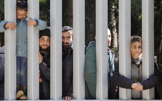 FILE - Members of a group of some 30 migrants seeking asylum are seen in Bialowieza, Poland, on Sunday, 28 May 2023.  Poland’s defense minister said Thursday that the metal barrier against illegal migration on border with Bealrus is being strengthened and plans are being made to reinforce the security of border with Russia. (AP Photo/Agnieszka Sadowska, File)
