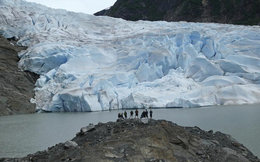 A group of people take in the views of the Mendenhall Glacier on June 8, 2023, in Juneau, Alaska. 