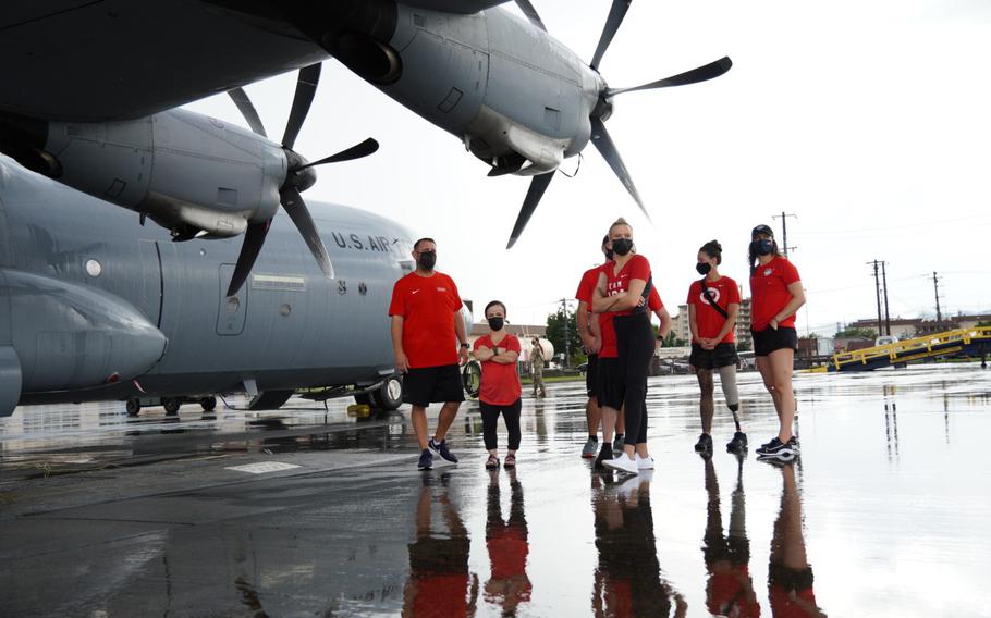 Members of the U.S. Paralympic team, photographed on Aug. 18, 2021, next to a C-130J Super Hercules, arrived at Yokota Air Base in western Tokyo, Japan. They will train there until the games begin Aug. 24, 2021.