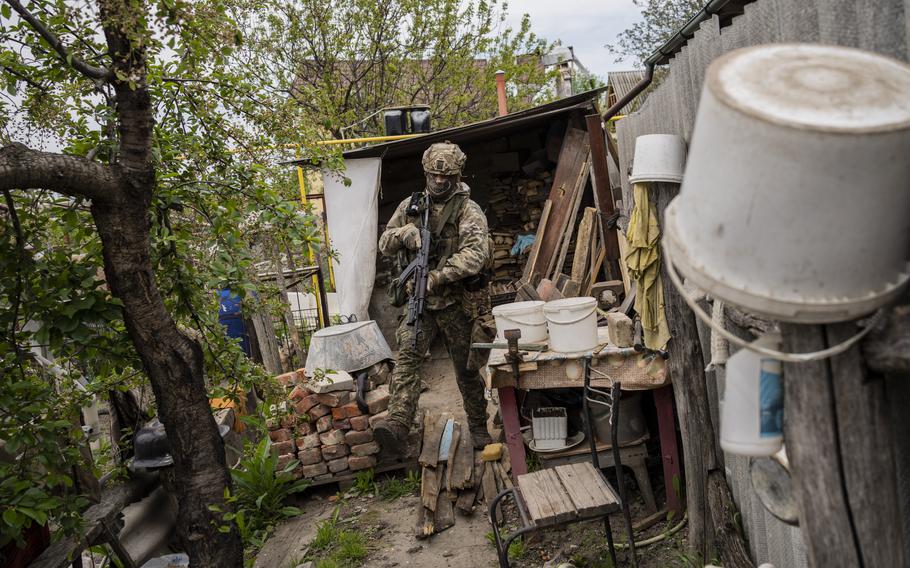 A Ukrainian National Guard soldier patrols during a reconnaissance mission in a recently retaken village on the outskirts of Kharkiv, east Ukraine, Saturday, May 14, 2022.