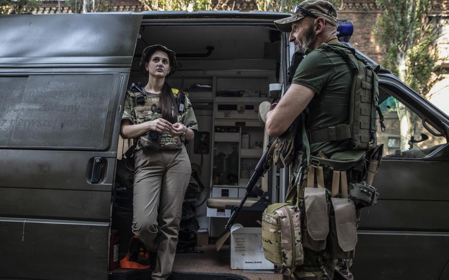 Liana Nigoyan, 24, and Annril Borysov, 53, both medics in the Ukrainian military, as they wait to deploy out of Bachmut, Ukraine on June 28, 2022.