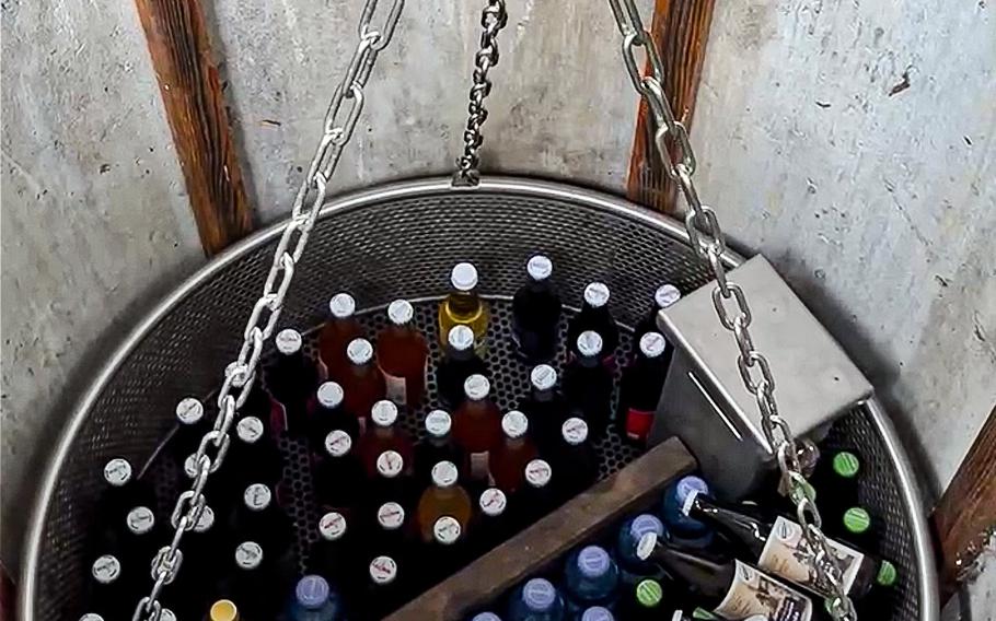 Beers are hoisted from the bottom of the emptied well on a trail near Gaming, Austria. 