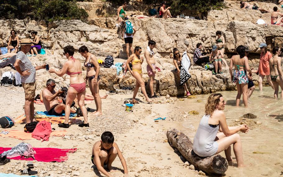 People rest on a beach in the National Park of Calanques, France, on June 12, 2021. 