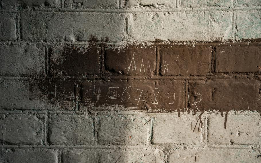 Alla’s name scratched onto the wall of the shed where she was held hostage and abused on the ground of a medical clinic that was used by Russian soldiers as a detention center and torture site in occupied Izium.