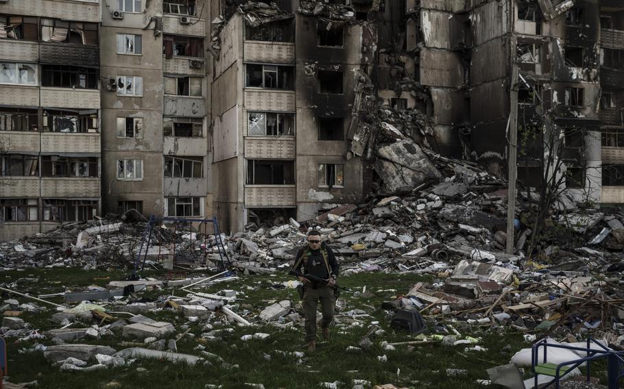 A Ukrainian serviceman walks amid the rubble of a building heavily damaged by multiple Russian bombardments near a front line in Kharkiv, Ukraine, Monday, April 25, 2022. 