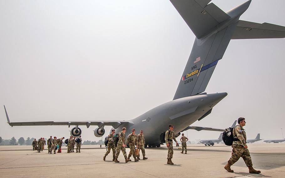 A group of airmen walk on the tarmac on June 29, 2023, at Selfridge Air National Guard Base in Michigan, after returning from Europe.