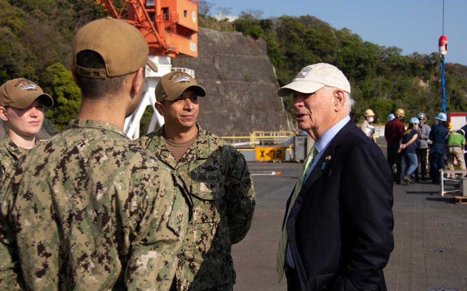 Sen. Ben Cardin, D-Maryland, meets with sailors on the flight deck of the aircraft carrier USS Ronald Reagan at Yokosuka Naval Base, Japan, Tuesday, April 12, 2022.