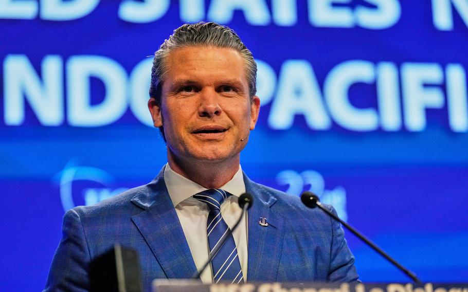 Hegseth at the microphone.