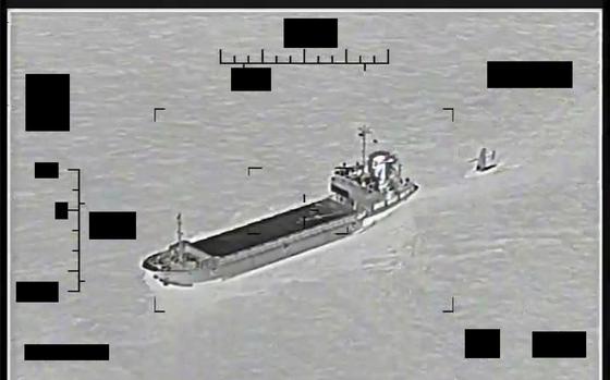 This photo released by the U.S. Navy shows the Iranian Revolutionary Guard ship Shahid Bazair, left, towing a U.S. Navy Saildrone Explorer in the Persian Gulf on Tuesday, Aug. 30, 2022.