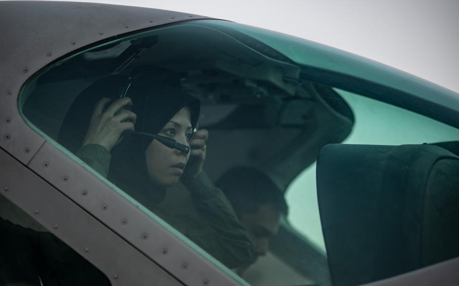 Afghan air force Capt. Safia Ferozi dons her headset before flight in Kabul, Afghanistan, in 2017. Ferozi flew a C-208 and was one of only a few female aviators in the country.