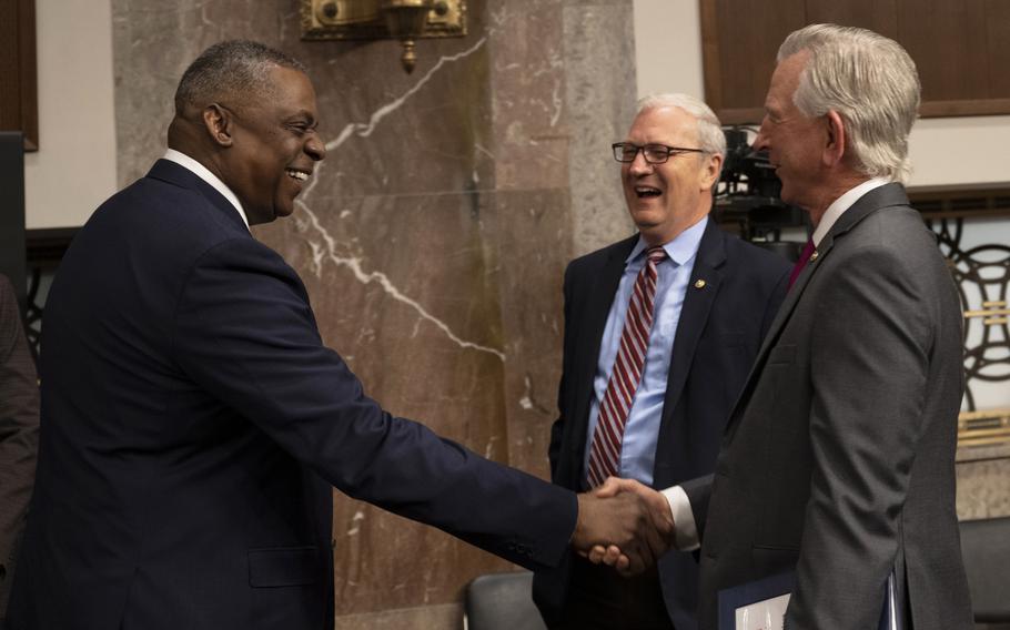 Secretary of Defense Lloyd J. Austin III greets Sens. Tommy Tuberville, right, and Kevin Cramer before a Senate Armed Services Committee hearing on the Defense Department’s fiscal year 2023 budget request, Washington, D.C., April 7, 2022.