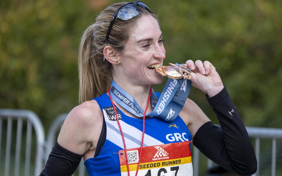 Tessa Barrett bites her medal