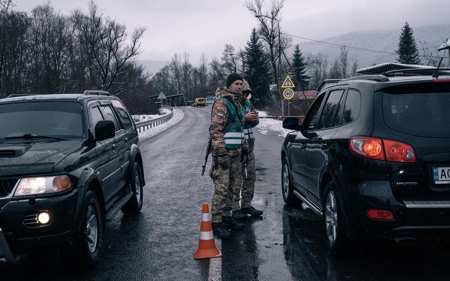 Members of Ukraine's State Border Guard Service stop cars at a checkpoint near the Romanian border in Veliatyno, Ukraine, in November. 