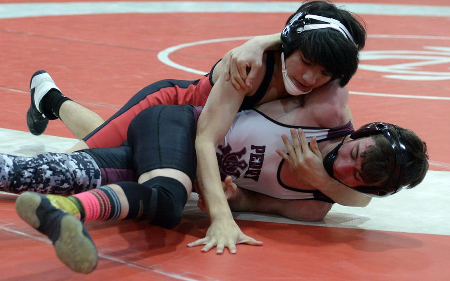 Nile C. Kinnick's Andrew Mincks gains control of Matthew C. Perry's James Williams at 135 pounds. Williams rallied to pin Mincks in 50 seconds for the title.