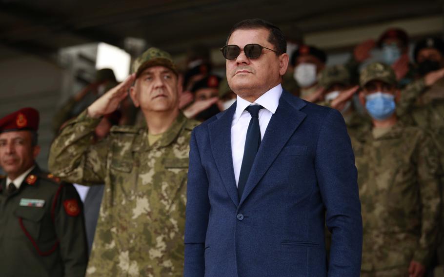 Prime Minister Abdul Hamid Dbeibah and the commander of the Turkish training mission in Libya attend the graduation ceremony of a batch of Libyan army cadets, in Tripoli, Libya, Tuesday, Feb. 8, 2022. 