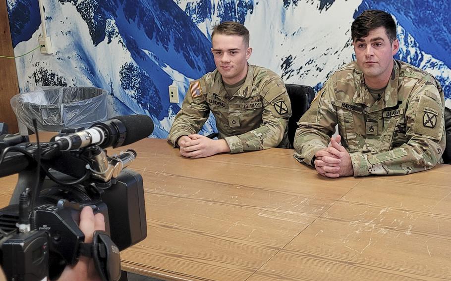 Pfc. Jacob Lundemo and Staff Sgt.  Joshua Hayes, both with B Company, 2nd Battalion, 87th Infantry Regiment, 2nd Brigade Combat Team, are interviewed by local media Oct. 19, 2022, a day after they helped rescue a civilian following a fuel truck explosion. 