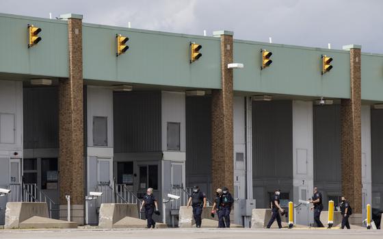 Border guards walk to their booths at the Ambassador Bridge in Windsor, Ontario, Canada, on May 26, 2021. MUST CREDIT: Bloomberg photo by Cole Burston