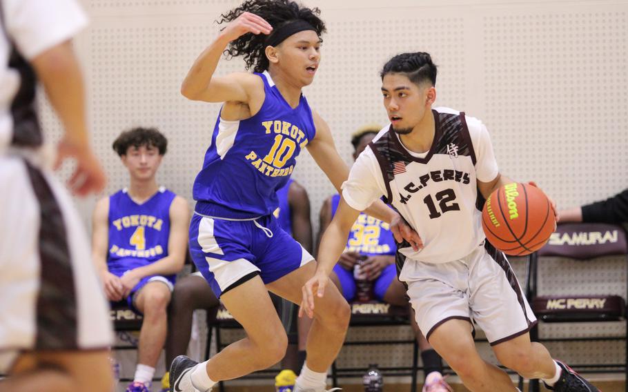 Matthew C. Perry's Joben Silang drives against Yokota's Royce Canta during Friday's DODEA-Japan season-opening boys basketball game. The Panthers won 59-27.