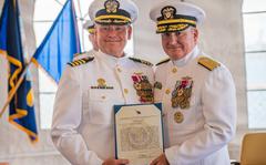 Rear Adm. Timothy Kott, Commander of Navy Region Hawaii, presented Capt. Erik Spitzer with the Legion of Merit Award for his service as commander of Joint Base Pearl Harbor-Hickam during a change-of-command ceremony June 14. 