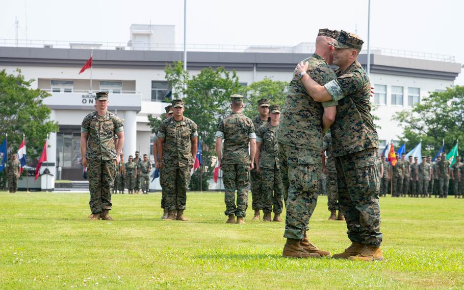 Col. Richard Rusnok congratulates Col. Kenneth Rossman during their change-of-command.