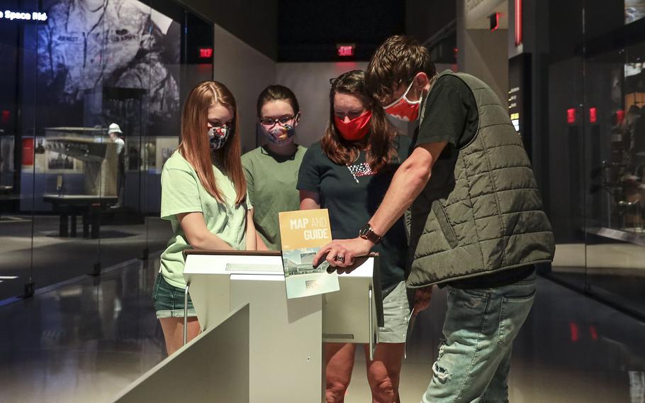 Visitors to the National Museum of the United States Army look at an interactive exhibit on the museum's reopening day, June 14, 2021.