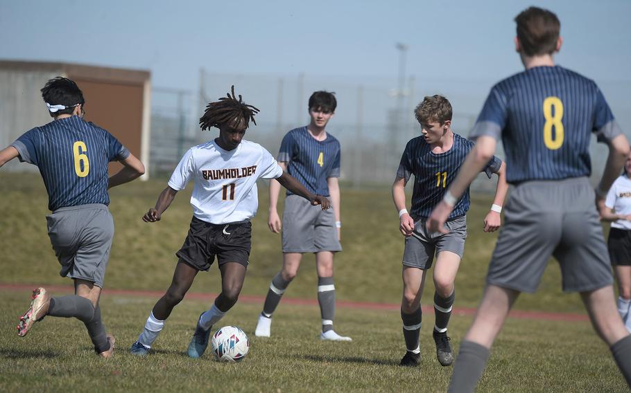Baumholder’s Jese Bogan dribbles past a sea of Ansbach defenders during their match Saturday, March 18, 2023.  