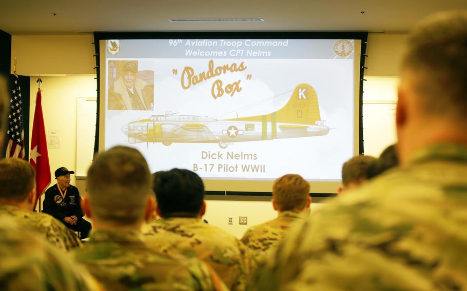 Brig. Gen. David Doran, assistant director, Army National Guard for Aviation, Intelligence and Information and Capt. Dick Nelms, World War II pilot join soldiers from the Washington Army National Guard for a presentation of the Knight of the Honorable Order of Saint Michael award at the Washington Army National Guard Aviation Readiness Center, Joint Base Lewis-McChord, Wash., on Sunday, March, 3, 2024.