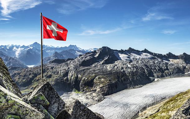 The Swiss flag waves in front of the Rhone glacier. RTT Travel Ramstein plans a Glacier Express tour within Switzerland on Aug. 7-10.