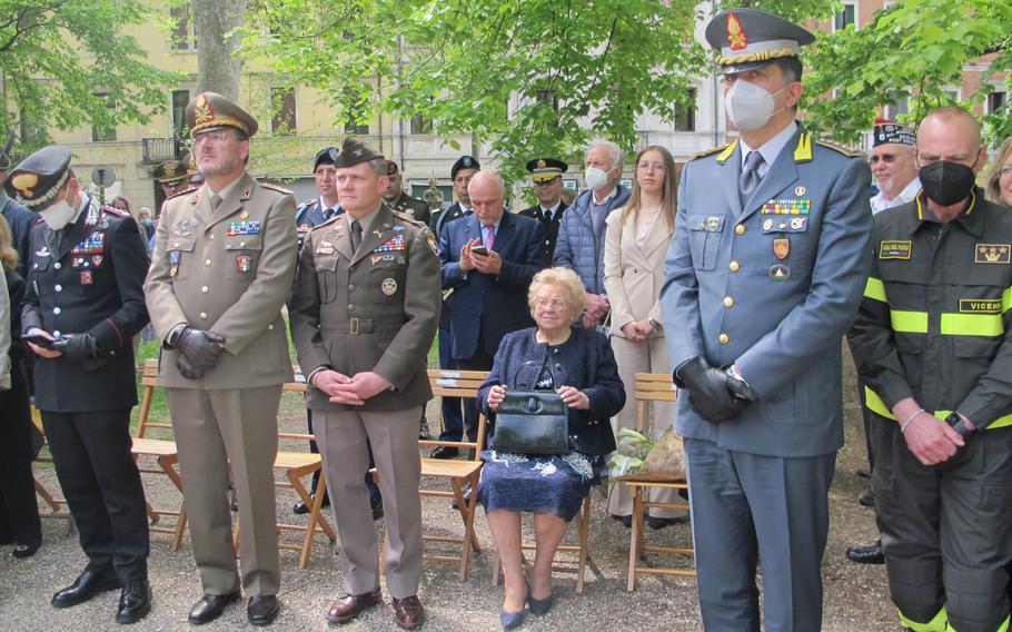 Col. Matthew Gomlak, the commander of U.S. Army Garrison Italy, left of Meri Mion, seated, wore his World War II-era jacket to co-host an event April 28, 2022, remembering the day 77 years ago when U.S. troops battled Germans for two hours to liberate the city. Gomlak also presented a birthday cake to Mion to replace one the American troops had made off with in 1945.