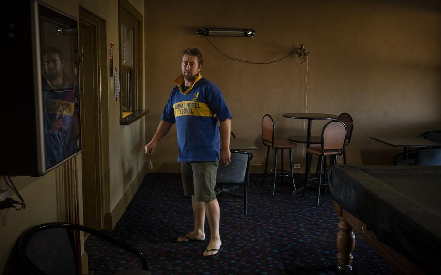 Mark Iles, publican at the Royal Hotel, holds a dead mouse in Yoeval, NSW, Australia, on May 28, 2021.