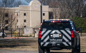 A law enforcement vehicle sits near the Congregation Beth Israel synagogue on January 16, 2022 in Colleyville, Texas. All four people who were held hostage at the Congregation Beth Israel synagogue were safely released after more than 10 hours of being held captive by a gunman.  (Brandon Bell/Getty Images/TNS)
