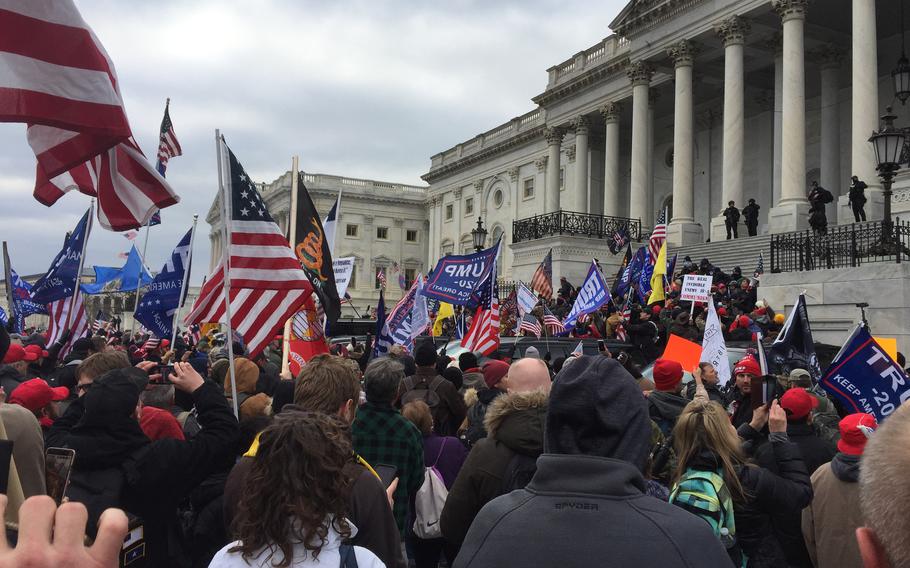 
A crowd of Trump supporters marching on the US Capitol on Jan. 6, 2021. A Navy reservist has been indicted in Virginia on charges of possessing unregistered firearms months after authorities in D.C. charged him with breaching the Capitol with the Proud Boys extremist group during the Jan. 6, 2021, attack.