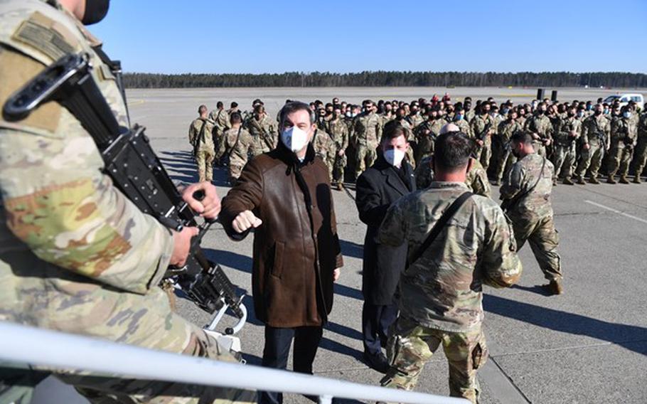 Bavarian governor Markus Soeder, second from left, welcomes U.S. soldiers of 1st Armored Brigade Combat Team, 3rd Infantry Division, upon their arrival at the Nuremberg Airport, Germany, March 1, 2022. The unit is slated to provide the most of the 7,000 service members ordered to deploy on a mission to support NATO allies.