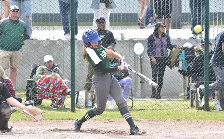 Naples' Jeweliana Martinez sends the ball to the outfield in the DODEA-Europe Division II/III softball championship game Saturday, May 20, 2023, at Kaiserslautern, Germany.