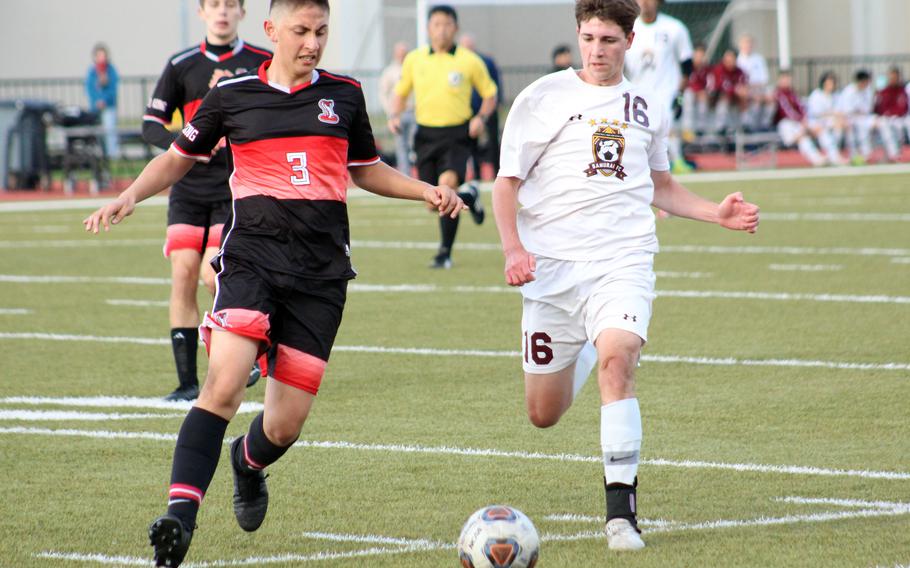 E.J. King's Roberto Vite and Matthew C. Perry's Isaac Hansen chase the ball during Friday's DODEA-Japan soccer match. The Samurai won 4-2.