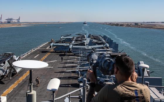 A Navy sailor stands watch on the USS Bataan as it transits the Suez Canal with the 26th Marine Expeditionary Unit on Aug. 6, 2023. Components of the Bataan Amphibious Ready Group and the Marine unit are deployed to the U.S. 5th Fleet area of operations to help ensure maritime security in the Middle East.