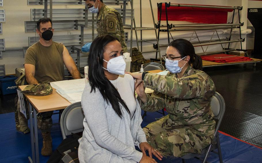 U.S. Air Force Maj. Aubrey Reid gives a booster shot to Yetta Lewis at a COVID-19 vaccination drive hosted by Landstuhl Regional Medical Center at Kleber Kaserne in Kaiserslautern, Germany, on Dec. 8, 2021. The Army has administered an estimated 25,000 booster doses to date at its base clinics in Europe.