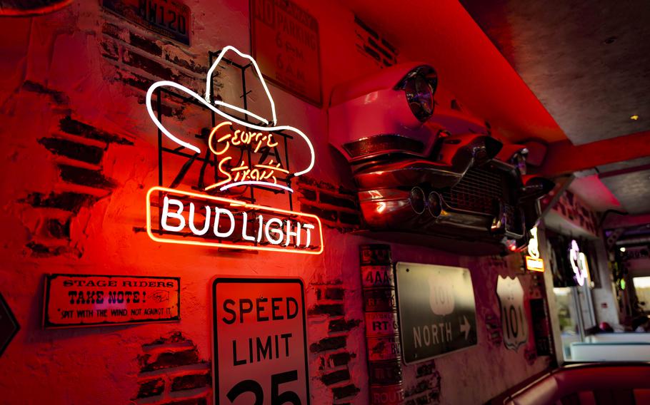A George Strait neon sign illuminates the Freeway Restaurant in Ruesselsheim, Germany, on Nov. 7, 2023. The decorations, a tribute to the open roads of the U.S., give the place a touch of Americana.
