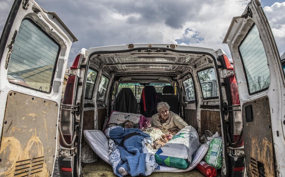 Elderly disabled women wait in the back of a van for assistance to board an evacuation train at the railway station in Pokrovsk, Ukraine, on May 28, 2022. Hours earlier, volunteers had evacuated them from a nursing home in Chasov Yar, a small town in Donetsk oblast less than 50 miles from Sievierodonetsk. 