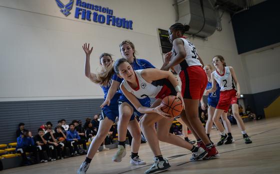 Nina Neroni of the American Overseas School of Rome twists away with the ball during a rebound play against the Rota Admirals at the DODEA European Division II basketball championships Feb. 15, 2023, at Ramstein Air Base, Germany. Rome bested the Admirals 40-17.