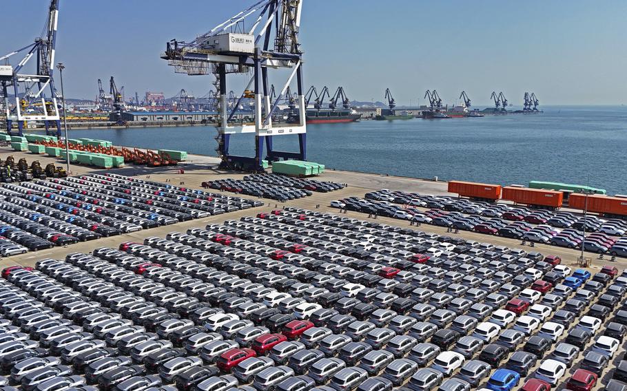 Rows of cars are seen at a pier.