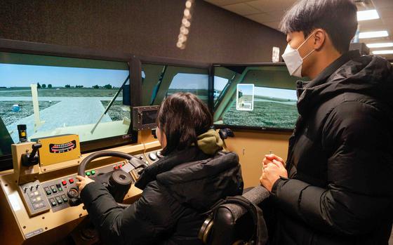 Pyeongtaek University students try out a combat vehicle simulator during a tour of Camp Humphreys, South Korea, Jan. 17, 2024. 
