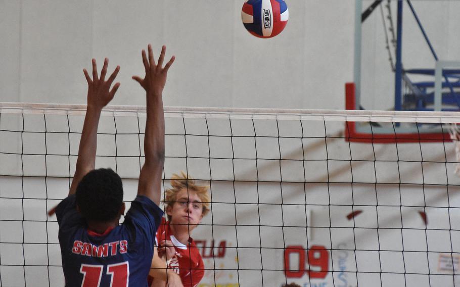 American Overseas School of Rome's Parker Huber gets a shot past Aviano's Nikko Monson on Saturday, Oct. 15, 2022, in the Saints' victory over the Falcons.